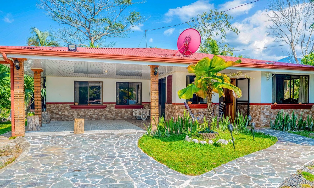 Garabito House | Palm-lined paradise with a pool, wood stove, & mountain views - dog-friendly