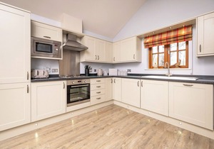 Spacious riverside lodge with mountain views.