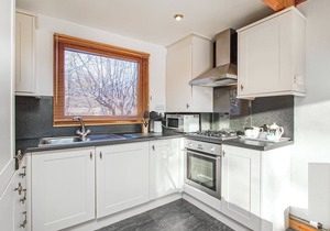 Spacious riverside lodge with mountain views.