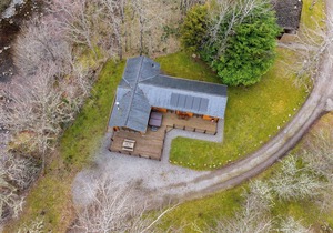 Spacious riverside lodge with mountain views.