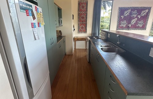 Raglan House | Sunny with decks and bush/harbour views. Three bedrooms. Pet friendly.