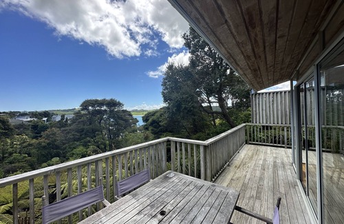 Raglan House | Sunny with decks and bush/harbour views. Three bedrooms. Pet friendly.
