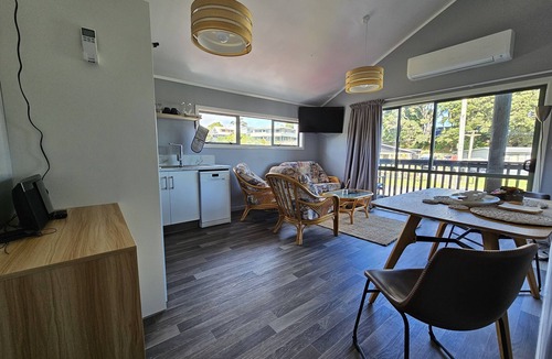 Maketu Apartment | Family room, come and enjoy the magical sunset on the balcony, Pet Friendly