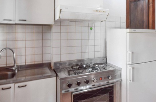 Praia a Mare Apartment | Practical apartment with open terrace and communal pool.