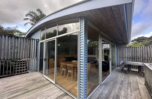 Raglan House | Sunny with decks and bush/harbour views. Three bedrooms. Pet friendly.