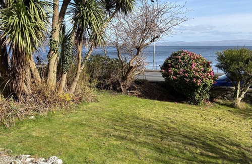 Port Bannatyne Apartment | Tideline. Waterfront ground floor spacious flat with garden and open sea views