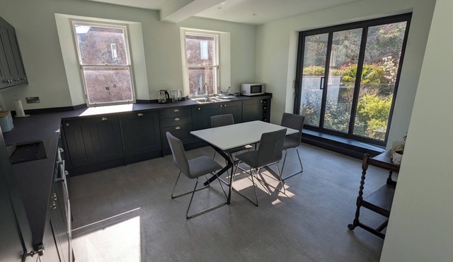 Central holiday home with pretty, sunny garden, moments from the station, golf course and beach.