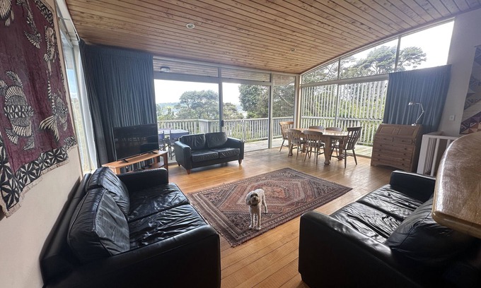 Raglan House | Sunny with decks and bush/harbour views. Three bedrooms. Pet friendly.